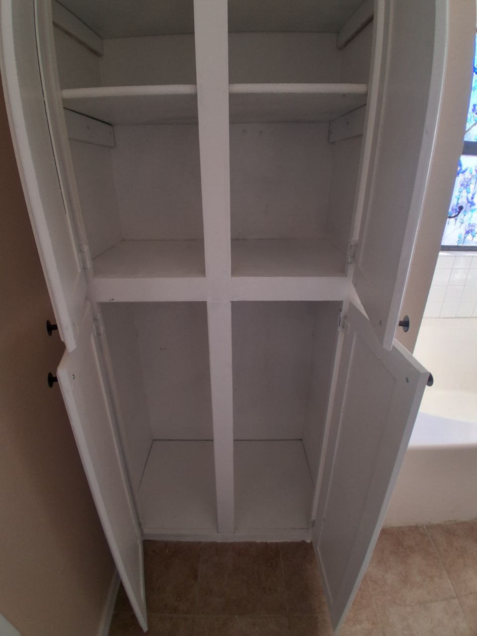 Built-in white shelves in a wall niche