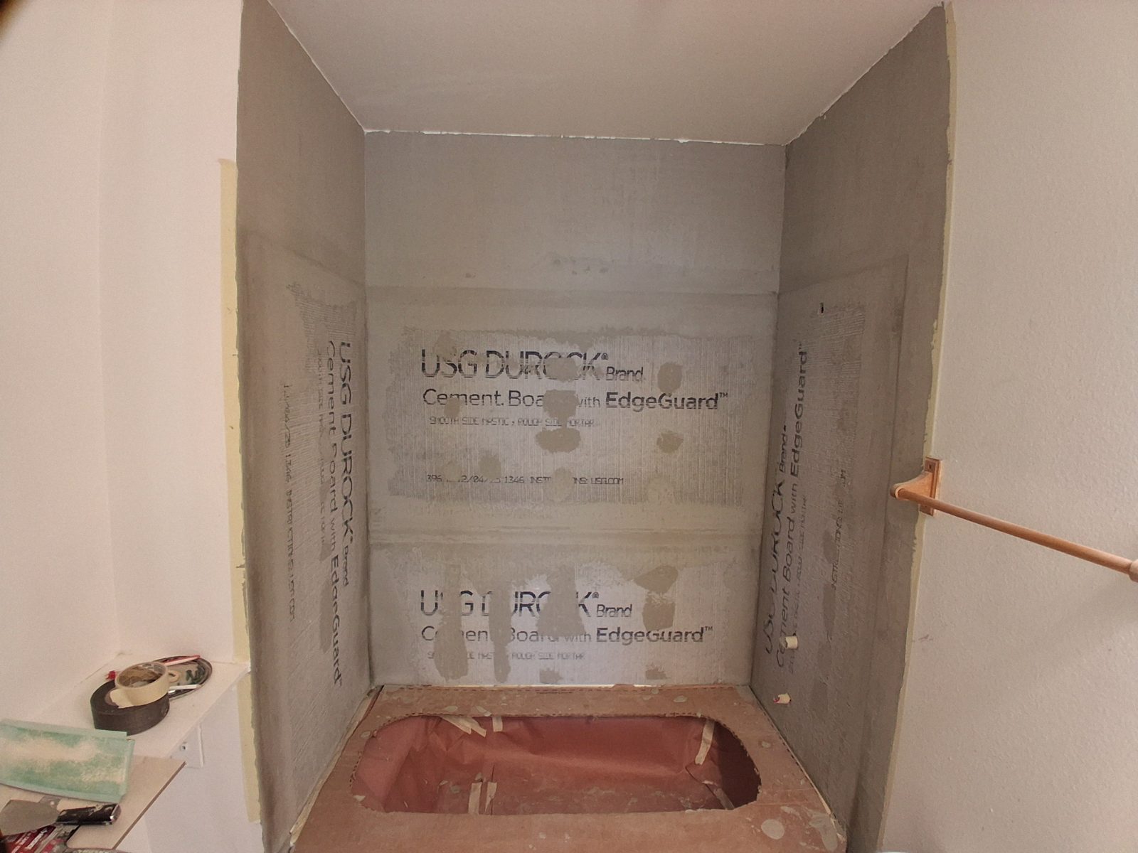 Shower stripped to new cement board walls before tile